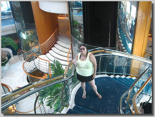 Rooty Jr. posing on the formal stairway to deck 6
