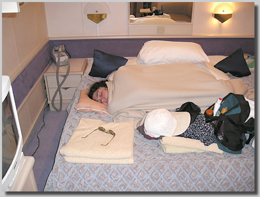 Ruthie all snuggled up in bed in cabin 4463 on deck 4. This was while I was away arranging for the video man for my marriage proposal that was in about an hour. It was just about the only part of this 7-day cruise that we were apart for any length of time.