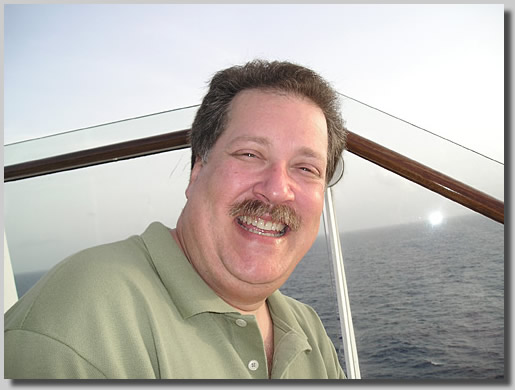 Dennis on the stairs up to deck 11 with a silly grin on his face.