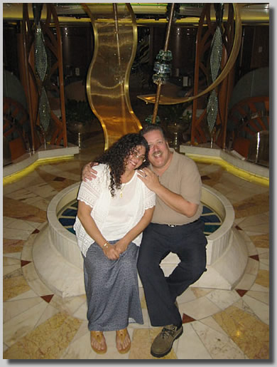 Ruthie and Dennis in front of a bizarre sculpture on deck 4