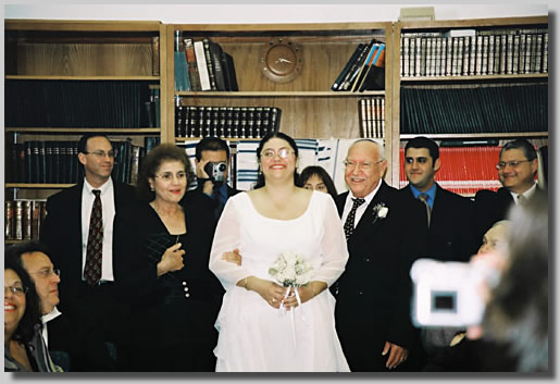 This is the wedding Processional with Rooty Jr. beaming as she is escorted in by Fortuna and Isaac, her parents.