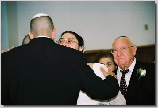 This is the wedding Processional with Rooty Jr. beaming as she is escorted in by Fortuna and Isaac, her parents. She is getting a kiss from Josh.